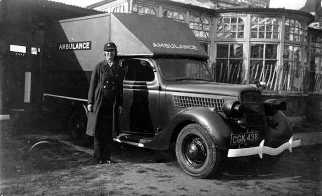 A woman ambulance driver outside its garage at Ewell Court. A woman ambulance driver outside its garage at Ewell Court.