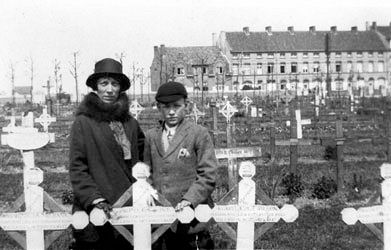 George's widow Lucy and their son Maurice visiting his grave in Ypres Reservoir Cemetery, Leper, West-Vlaanderen, Belgium