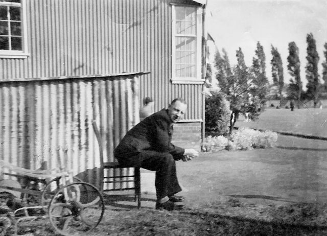 Jim Alderson sitting next to the West Park Hospital Bowling Green c.1950's