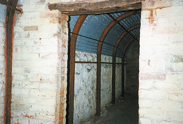 Corridor with roof lined with galvanised corrugated iron sheeting.