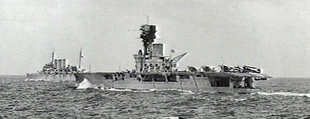 HMS Hermes (and, behind, HMS Dorsetshire) escorting a convoy in June 1940