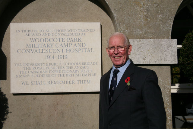 Graham Deeprose standing beside the plaque that he campaigned for.