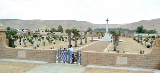The entrance to the Halfaya Sollum War Cemetery in 2013, with caretaker and family.