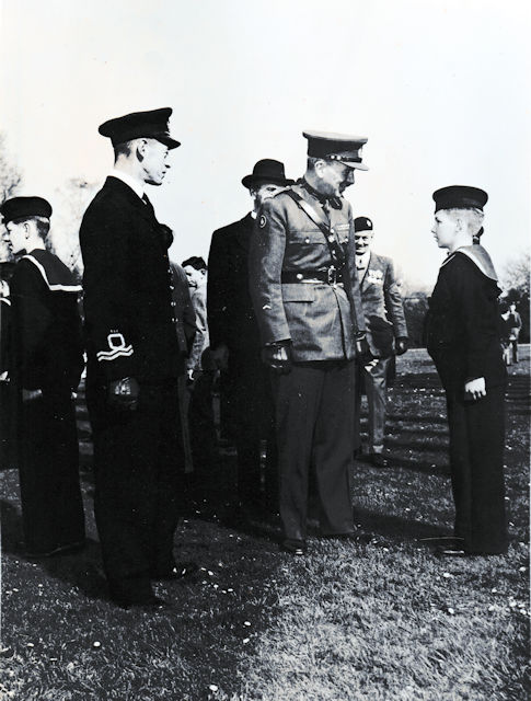 Lt. Cdr. Norman King Sanders, RNVR, first Commanding Officer of TS Foxhound, with Canadian personnel, inspecting the local Sea Cadets.