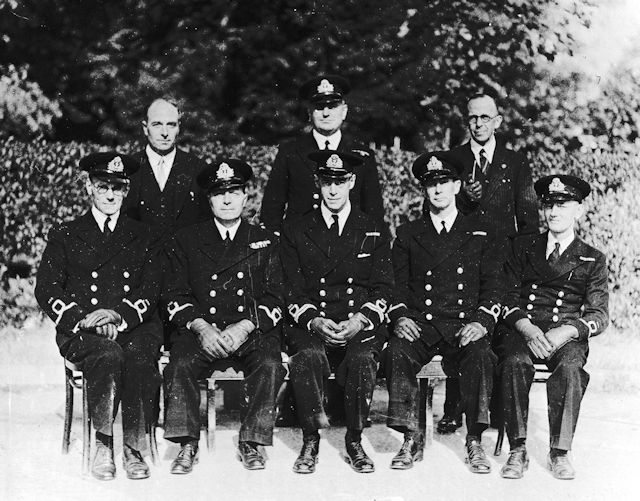 Lt.Cdr. Sanders (centre) with other officers and dignitaries.