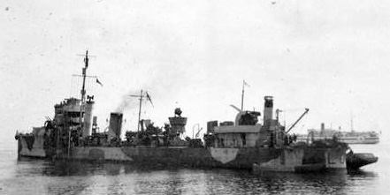 HMS Wryneck (with a tug alongside), probably at Sollum, Egypt. HMS Wryneck (with a tug alongside), probably at Sollum, Egypt.