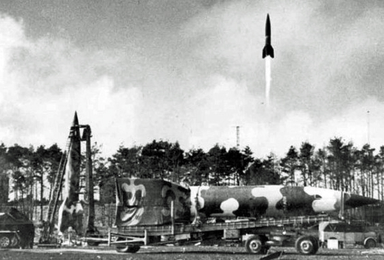 A just-launched V2 rocket with others in preparation from their elusively mobile launchers