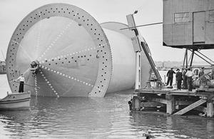 A 'Conundrum' being moved into position into a specially constructed dock in preparation for the winding on of the pipe.